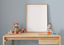Empty Vertical Picture Frame Standing On The Desk In Modern Child Room. Frame Mock Up In Contemporary Style. Free, Copy Space For Picture, Poster. Plush And Wooden Toys. Close Up View. 3D Rendering.