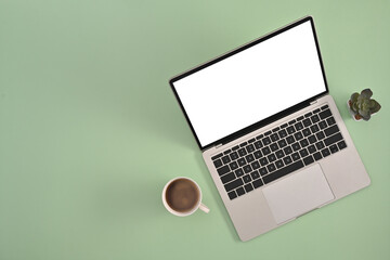 Poster - Top view of Creative office desk concept, Laptop with empty screen, cup of coffee on the light pastel green background.