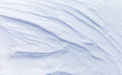 White abstract natural background of the snowy ice surface of Baikal  Lake on a frosty windy day. Top view of the layered structure of the snow crust. Flat lay, copy space, mockup