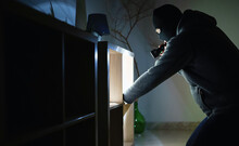 Masked Robber With Flashlight Torch Checking Apartment.