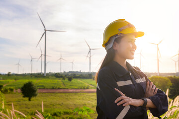 a woman engineer is putting a protective helmet on her head at sunset.