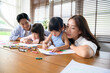 © tonefotografia - Asian family with children Drawing and painting on table in playing room at home, Educational game.