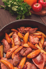 Wall Mural - Ojakhuri, Traditional Georgian dish, fried potatoes with meat, in a clay frying pan, top view, no people, homemade,