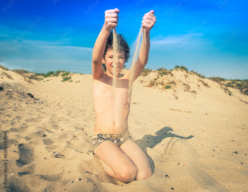 little kid nudist boy Cute little brunet boy on the beach plays with sand. kids travel concept.  Sea holidays, copy space. の Stock フォト | Adobe Stock