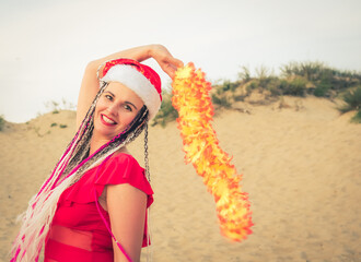 Wall Mural - Happy middle aged attractive brunette woman in red swimsuit and Santa hat having fun on the coast. Christmas holiday vacation and travel concept.