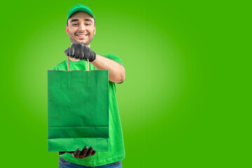 Delivery man with paper bag. Courier in uniform cap t-shirt, gloves service fast delivering orders. Young guy holding a cardboard package. Character on isolated white background for mockup design