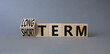 Long term vs Short Term symbol. Turned wooden cubes with words Long term and Short Term. Beautiful grey background. Business concept. Copy space.
