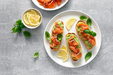 Wall Mural - Toasts with salted salmon and avocado guacamole, top view