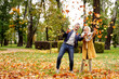 © neonshot - Happy married Couple having fun together outdoor in the golden autumn park, throwing leaves and laughing. Wife and husband in love. Real people emotions
