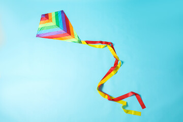 Wall Mural - Bright rainbow kite on light blue background, top view