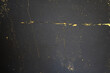 Background designed with golden metal cracks shining on grungy dark gray concrete texture. Dark gray and gold background.