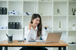 © aekachai - Asian businesswoman chatting with customers via laptop online
