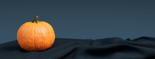 Contemporary Autumn Background With Pumpkin On Blue Grey Blanket.