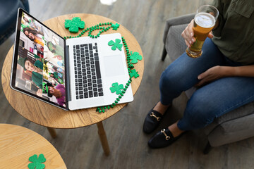 Poster - Mid section of woman holding beer while having a video conference on laptop at a bar