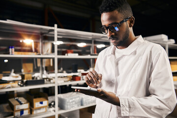 Wall Mural - african engineer working with tablet at factory