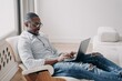 © VK Studio - Focused african american businessman working typing on laptop sitting in chair at home office