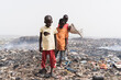 © Riccardo Niels Mayer - Sleazy, unkempt boys hanging around in an African garbage dump in search of things to eat and sell