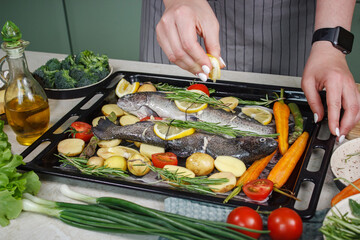 Cooking sea bass fish with aromatic herbs and vegetables