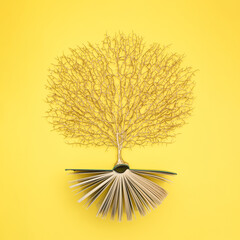 golden tree growing from the old book, education and knowledge concept. for book lovers. flat lay.