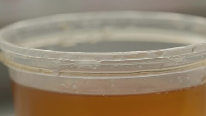 Poster - a jar of bee honey rotates in a circle