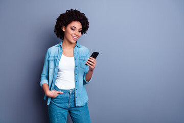 Wall Mural - Photo of attractive cheerful lady hold use telephone empty space blank isolated on grey color background