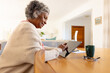 © Wavebreak Media - Senior african american women using tablet and drinking coffee