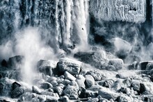 Dramatic Greyscale Shot Of Waterfalls Splashing To The Rocks