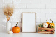 Picture Frame Mockup With Wooden Box Of Decorative Pumpkins, Vase Of Dry Wheat On White Table In Nordic Room Interior.