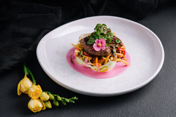 Beef medallions with fresh salad on plate