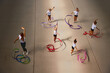 © master1305 - Aerial view. Female sports coach training gymnastics athletes at sports gym, indoors. Concept of sport, studying, art, education