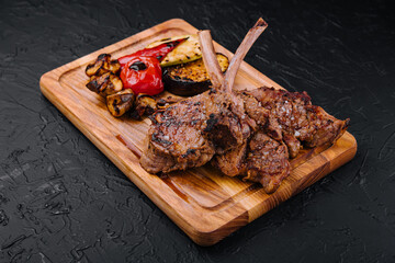 Wall Mural - Tasty grilled lamb ribs with vegetables on board