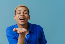Blonde Young Man Wearing Shirt Laughing And Holding Copyspace