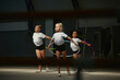 © master1305 - Flexible little girls, female rhythmic gymnasts training with gymnastic hoop at sport gym, indoors. Concept of action, motion, sport, motivation, competition.