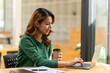 © PaeGAG - Asian woman working with laptop in her office. business financial concept.