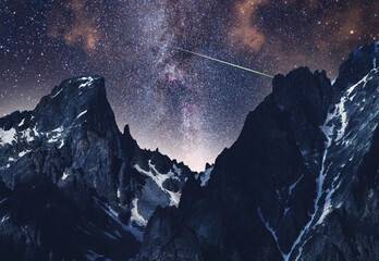 Wall Mural - Beautiful fantasy night mountains landscape. Snow covered mountains under starry sky with bright milky way galaxy. 