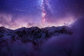 Wall Mural - beautiful fantasy night mountains landscape. snow covered mountains under starry sky with bright mil