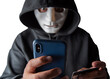 An anonymous masked hacker is using a smartphone to penetrate credit card financial information with clipping path. Hacking and malware concept.