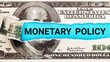 Monetary policy. Torn bills revealing Monetary Policy words. Ideas for Increase or Decrease interest rates, Stimulate the economy, Moneyless valuable