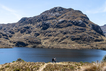 Wall Mural - Tourists are on the high coast of the mountain lake Toreadora in El Cajas National Park on altitud 3900 m above sea level. Ecuador