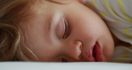 Baby sleeping. Cute infant face close-up asleep. Adorable one year old toddler boy napping macro closeup