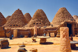 Fototapeta  - Traditional mud brick made beehive houses. Harran, major ancient city in Upper Mesopotamia, nowadays is a district in Sanliurfa province, Turkiye. Village of beehive houses opposite clear sky