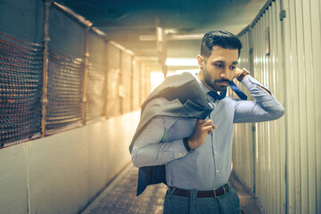 Portrait of young business man hurrying through the passage. Copy space.