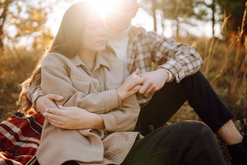 Wall Mural - Young couple in love walking in the park on a autumn day. Enjoying time together.