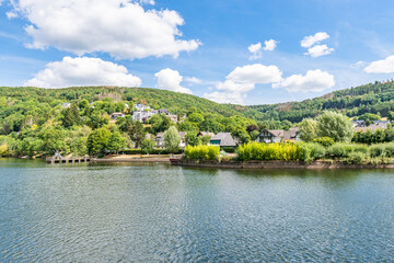 Wall Mural - Some houses at the shore of lake Rursee, In the middle of the Eifel National Park, surrounded by unique natural scenery and unspoilt nature