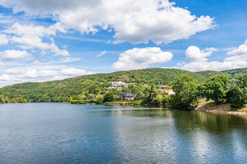 Wall Mural - Some houses at the shore of lake Rursee, In the middle of the Eifel National Park, surrounded by unique natural scenery and unspoilt nature