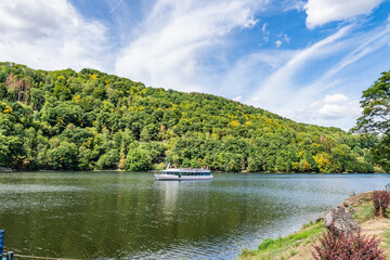 Wall Mural - Boat with tourists on Lake Rursee, In the middle of the Eifel National Park, surrounded by unique natural scenery and unspoilt nature