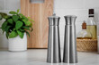 Stainless steel salt and pepper shakers on table, space for text
