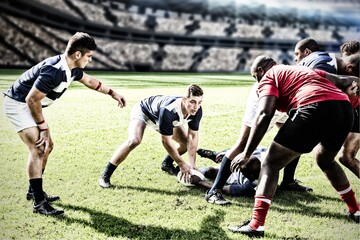 Canvas Print - Digital composite image of team of rugby players playing rugby in sports stadium