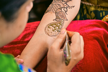 Wall Mural - Applying henna tattoo on a bride hands. Brown Colors of Henna Ink. Indian Wedding Traitional Mehendi Ceremony.