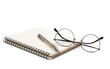 Notepad with pen and glasses on a white background.